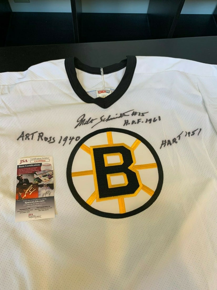 Milt Schmidt Signed Boston Bruins Jersey with JSA COA: Milt Schmidt Signed Boston Bruins Jersey with JSA COA Celebrate the legacy of hockey with this authentic Boston Bruins jersey, boldly signed and heavily inscribed by the legendary Milt Schmidt. This o
