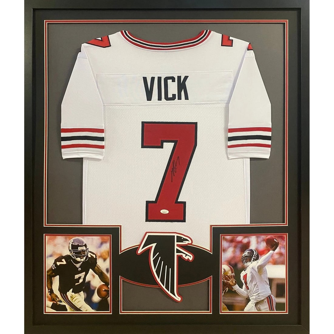 Framed Michael Vick autographed white TB jersey JSA authenticated Atlanta Falcons: Framed Michael Vick autographed white TB jersey JSA authenticated Atlanta Falcons This is a framed, autographed white Tampa Bay style jersey signed by Michael Vick of the Atlanta Falcons. The jersey c