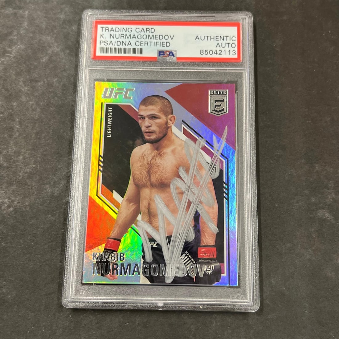 2021 Panini Chronicles Elite Khabib Nurmagomedov Autographed Card PSA Certified: 2021 Panini Chronicles Elite Khabib Nurmagomedov Autographed Card PSA Certified This is a 2021 Panini Chronicles Elite #146 sports trading card featuring the signature of Khabib Nurmagomedov, a promin