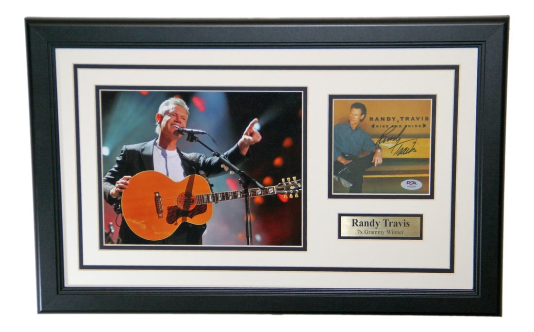 Framed Randy Travis signed CD cover with photo PSA DNA: Framed Randy Travis signed CD cover with photo PSA DNA Framed display featuring an original autographed Randy Travis CD cover with a photo. The autograph is authenticated by PSA/DNA. Pre-owned conditi