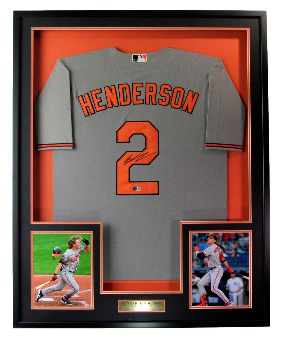 Framed Gunnar Henderson Orioles signed baseball jersey BAS authenticated: Framed Gunnar Henderson Orioles signed baseball jersey BAS authenticated This framed display features a Baltimore Orioles gray baseball jersey signed by Gunnar Henderson, accompanied by photos. The je