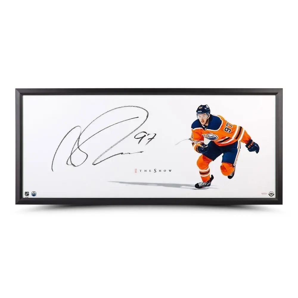 Framed Connor McDavid Autographed 20X46 Oilers Photo The Show Point of Attack: Framed Connor McDavid Autographed 20X46 Oilers Photo The Show Point of Attack This is a framed 20x46 photo featuring Connor McDavid of the Edmonton Oilers, personally signed by the player. The autogra