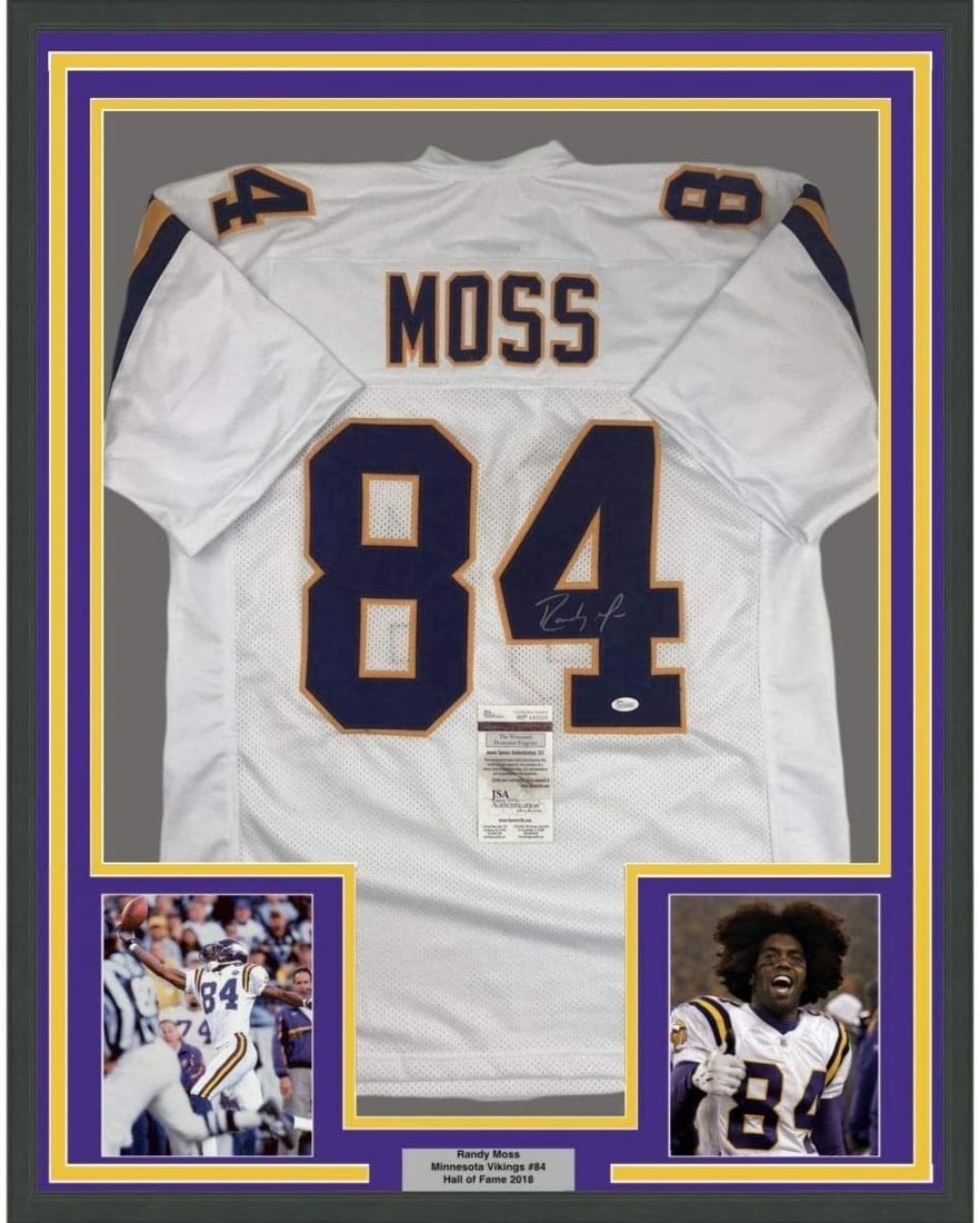 Randy Moss Signed Framed Minnesota Vikings White Jersey JSA 35x39: Randy Moss Signed Framed Minnesota Vikings White Jersey JSA 35x39 Professionally framed and matted white Randy Moss signed jersey display featuring two 5x7 photos. This original autographed football c