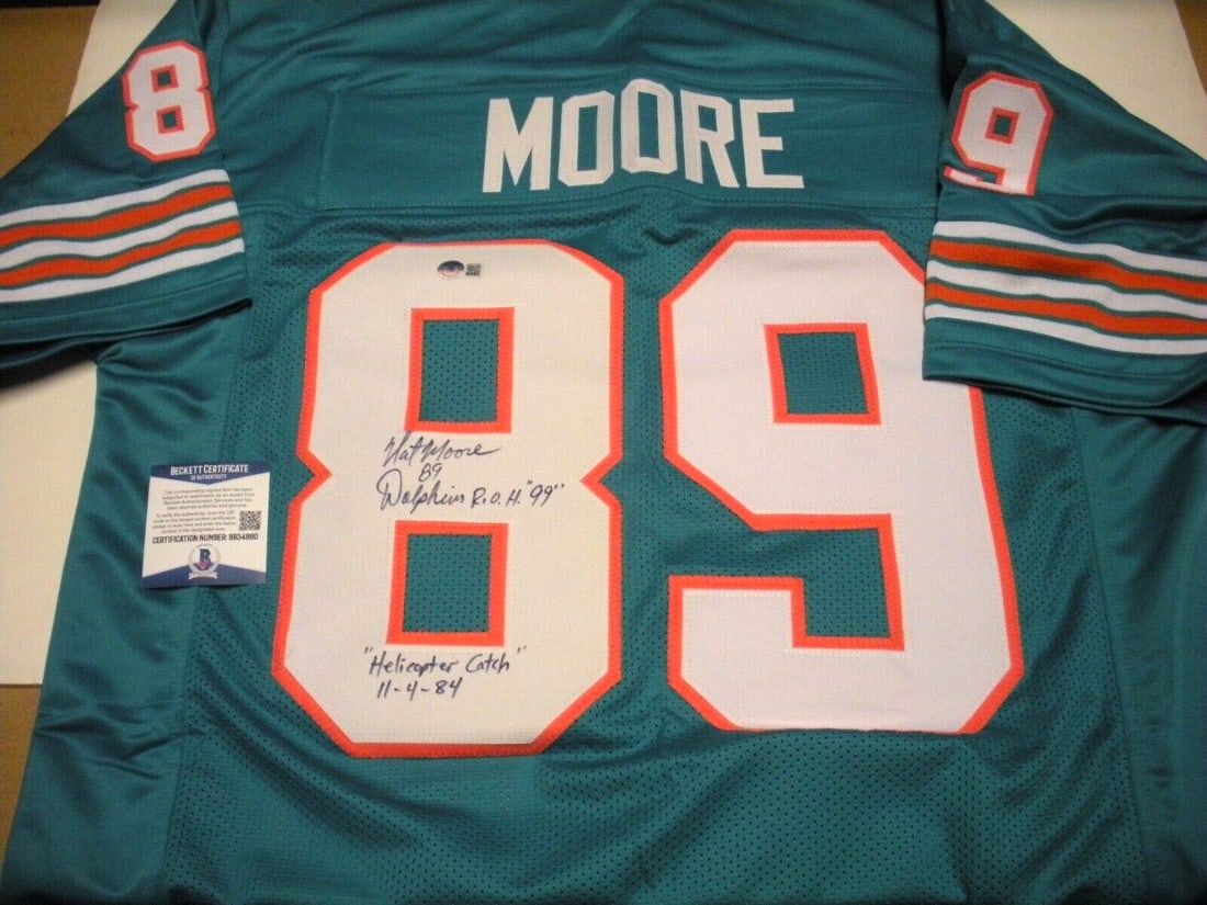 Signed Nat Moore Jersey Miami Dolphins 1984 Beckett COA Authentic Autograph: Signed Nat Moore Jersey Miami Dolphins 1984 Beckett COA Authentic Autograph This is a pre-owned Miami Dolphins football jersey signed by Nat Moore, commemorating his iconic 1984 helicopter catch. The 