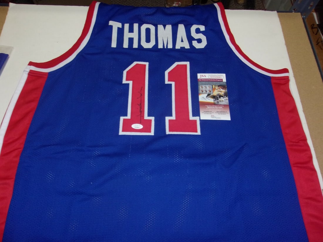 Autographed Isiah Thomas Detroit Blue Jersey With JSA COA Two-Time NBA Champion: Autographed Isiah Thomas Detroit Blue Jersey With JSA COA Two-Time NBA Champion This pre-owned blue Detroit Pistons jersey is signed by Isiah Thomas, commemorating his achievements as a two-time NBA c