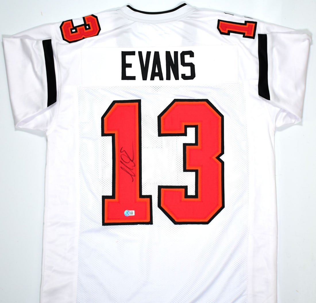Signed Mike Evans White Football Jersey Beckett BAS Buccaneers: Signed Mike Evans White Football Jersey Beckett BAS Buccaneers Autographed white pro style football jersey signed by Mike Evans. The jersey is an original item associated with the Tampa Bay