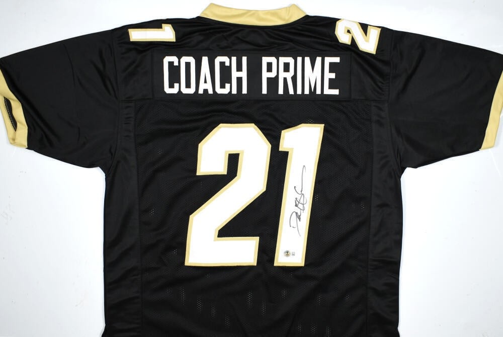 Black college style jersey signed by Deion Sanders Beckett holo: Black college style jersey signed by Deion Sanders Beckett holo Pre-owned black college style jersey autographed by Deion Sanders. The item includes a Beckett witness hologram and was made in the Unit