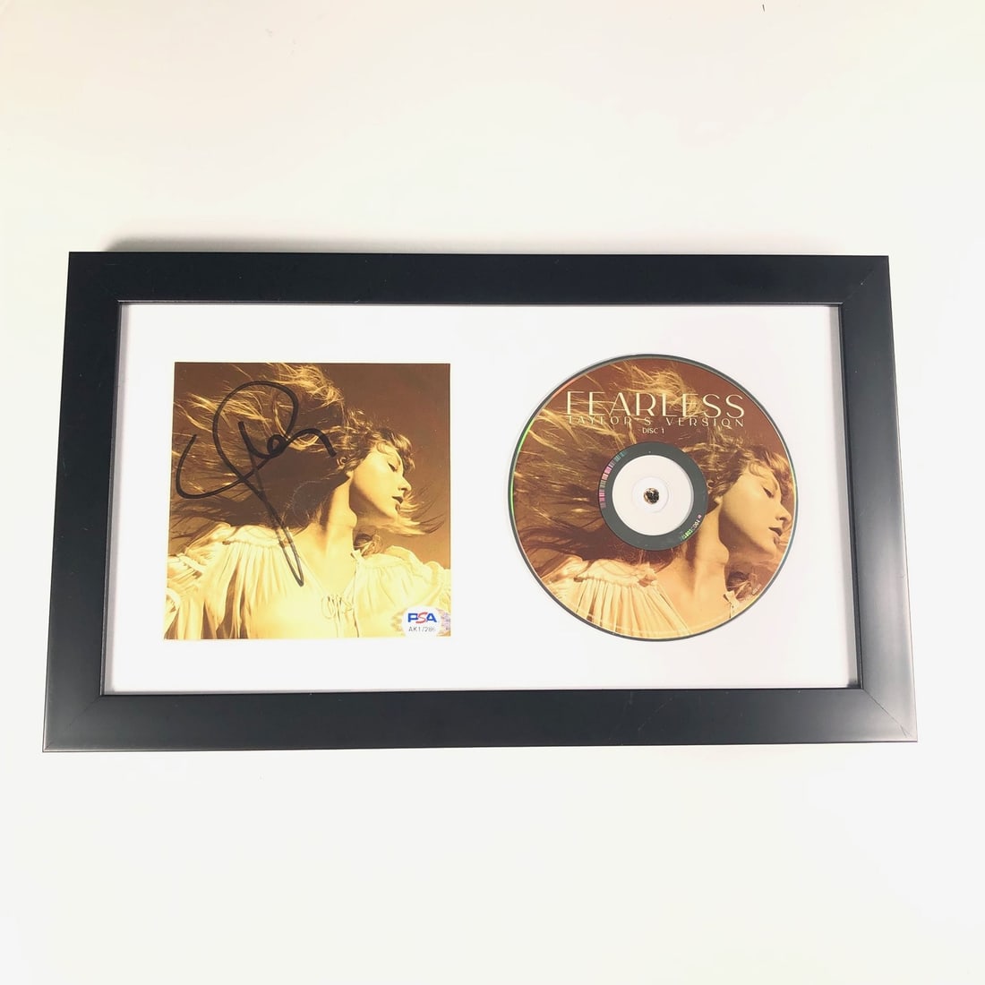 Framed Taylor Swift Fearless CD Cover Signed PSA/DNA Authentic: Framed Taylor Swift Fearless CD Cover Signed PSA/DNA Authentic This framed CD album cover features a striking design and showcases the authentic autograph of Taylor Swift, verified by PSA/DNA for auth