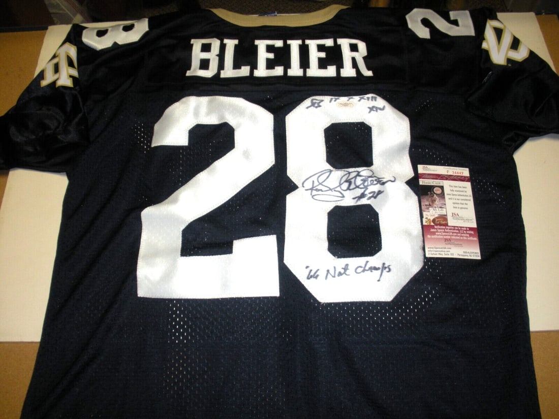 Signed Champion Notre Dame Jersey Rocky Bleier JSA Authenticated: Signed Champion Notre Dame Jersey Rocky Bleier JSA Authenticated This is an officially licensed Notre Dame Irish Champion jersey autographed by Rocky Bleier. The jersey is an original collectible and 