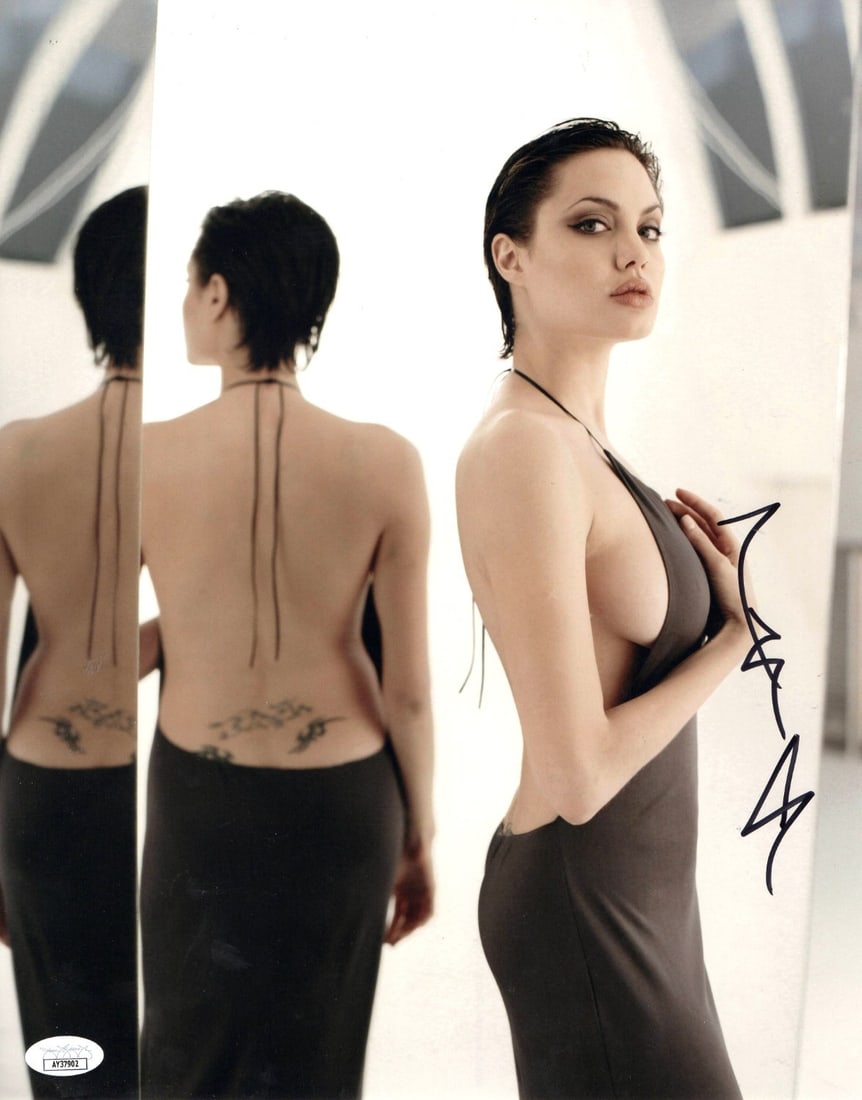 Angelina Jolie 11X14 Autographed Photo with JSA Certification: Angelina Jolie 11X14 Autographed Photo with JSA Certification This stunning 11x14 photograph features the iconic Angelina Jolie, showcasing her captivating presence and unique tattoos. The photograph 