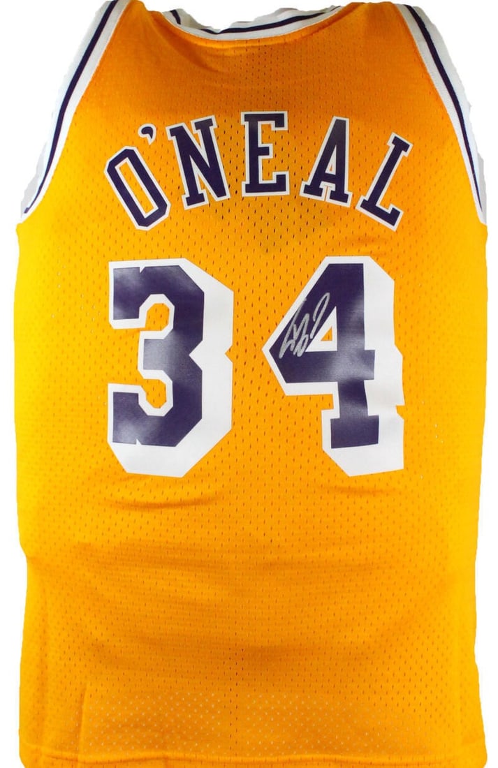 Mitchell Ness HWC Swingman Lakers Gold Jersey signed by Shaquille O'Neal: Mitchell Ness HWC Swingman Lakers Gold Jersey signed by Shaquille O'Neal This is an original Los Angeles Lakers basketball jersey signed by Shaquille O'Neal. It is described as a gold Mitchell & Ness