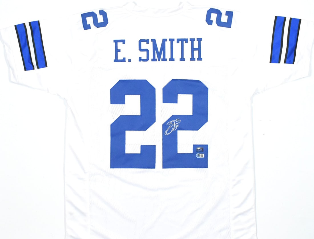 White Pro Style Jersey Signed by Emmitt Smith Beckett Hologram Silver: White Pro Style Jersey Signed by Emmitt Smith Beckett Hologram Silver Pre-owned white pro style jersey autographed by Emmitt Smith. The jersey includes a Beckett Witness hologram for authentication. S