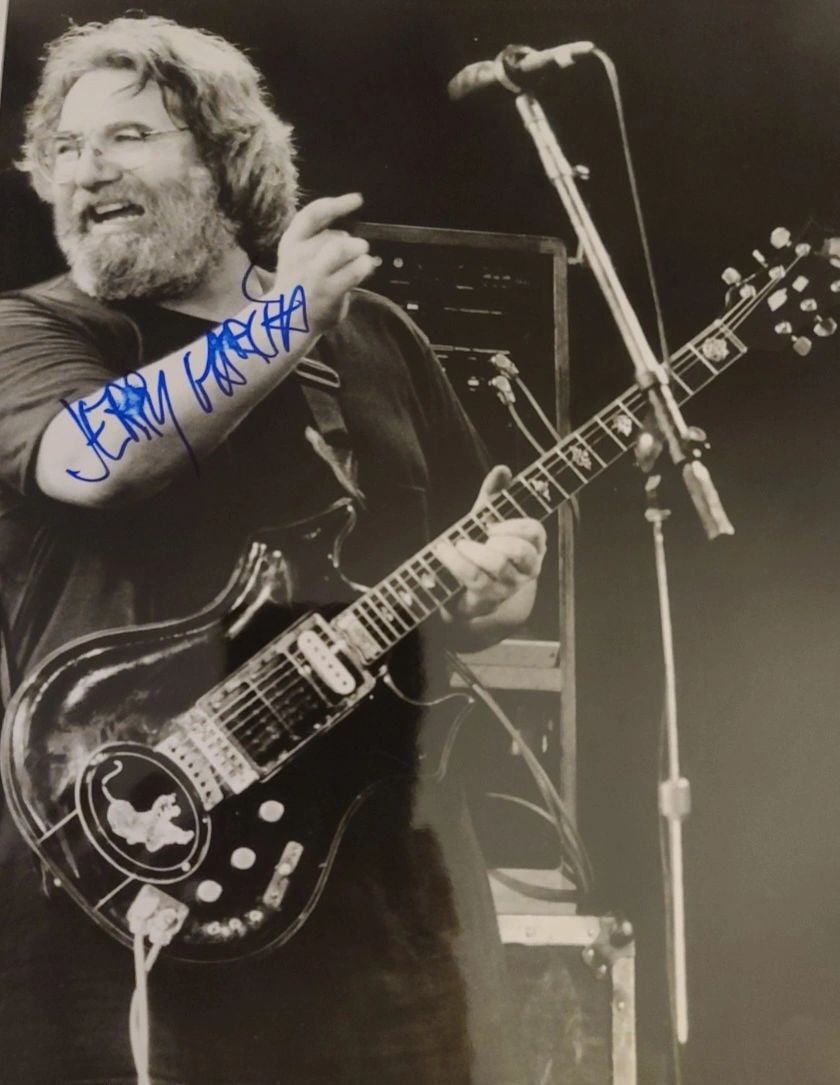Autographed 8x10 Photo of Jerry Garcia with Todd Mueller LOA: Autographed 8x10 Photo of Jerry Garcia with Todd Mueller LOA Signed 8 x 10 photograph of Jerry Garcia featuring a signature placed along the neck area. Presented in excellent pre-owned condition and a