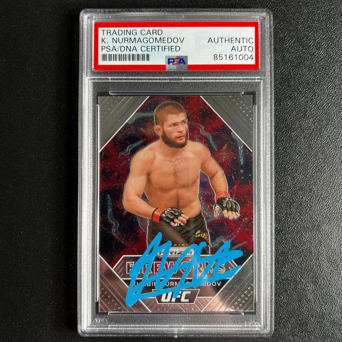 2021 Panini Prizm Khabib Nurmagomedov Signed Card PSA Authenticated: 2021 Panini Prizm Khabib Nurmagomedov Signed Card PSA Authenticated Up for sale is a 2021 Panini Prizm #18 sports trading card autographed by Khabib Nurmagomedov, a renowned mixed martial artist. This