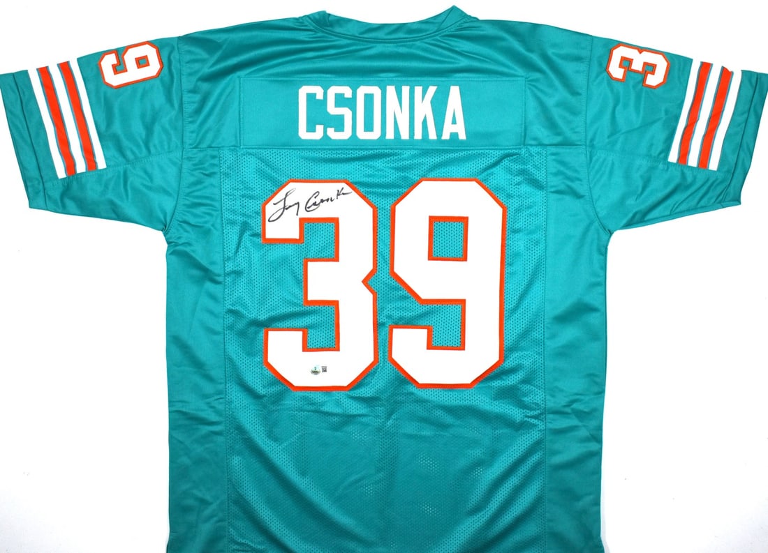 Larry Csonka Signed Teal Miami Dolphins Jersey Beckett Authenticated: Larry Csonka Signed Teal Miami Dolphins Jersey Beckett Authenticated This is a teal pro style football jersey autographed by Larry Csonka. The jersey features a Beckett Witnessed hologram for authenti
