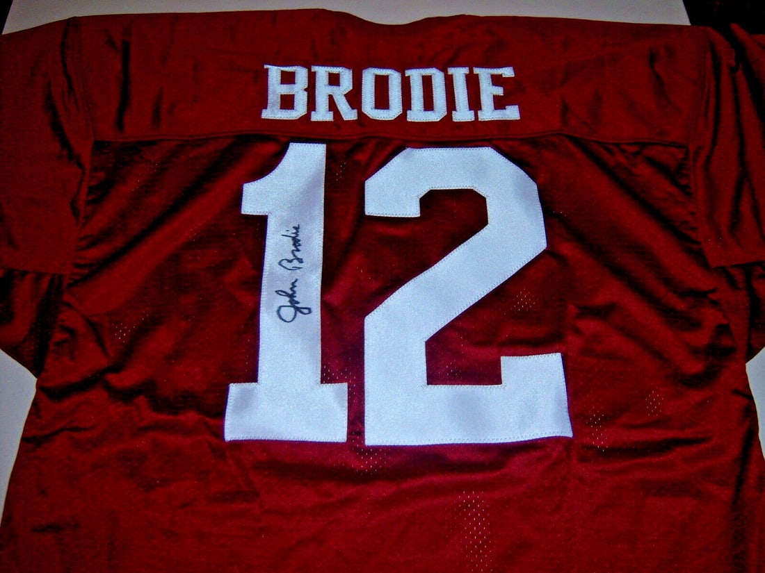 Autographed John Brodie Football Jersey With COA Stanford and 49ers: Autographed John Brodie Football Jersey With COA Stanford and 49ers This pre-owned jersey is signed by John Brodie and represents both the Stanford Cardinal and San Francisco 49ers. It is an original 
