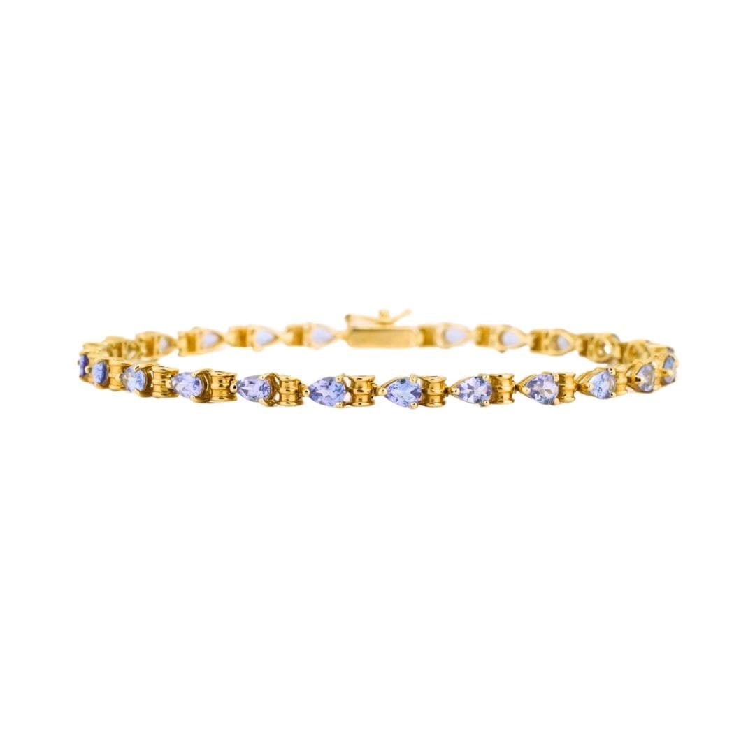 Unbranded 14K Yellow Gold Tanzanite Tennis Bracelet Pear Cut 7 In: Unbranded 14K Yellow Gold Tanzanite Tennis Bracelet Pear Cut 7 In A pre-owned 14K yellow gold tennis bracelet set with natural pear shape tanzanite stones in a pale lavender color. This delicate, well