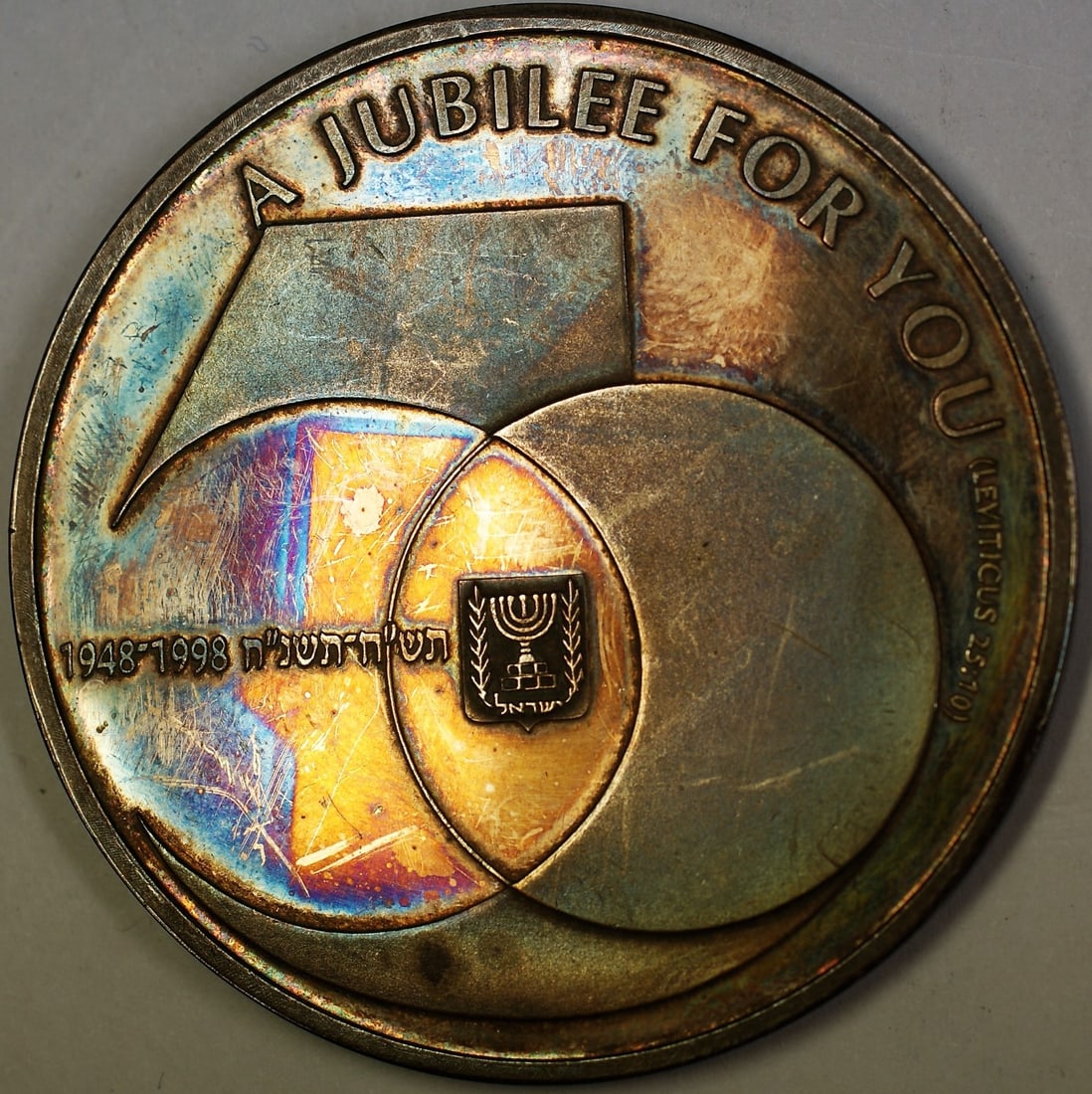 Israel 50th Jubilee State Uncirculated Medal 9999 Fine Silver Rainbow Toned: Israel 50th Jubilee State Uncirculated Medal 9999 Fine Silver Rainbow Toned This 50 Jubilee State medal commemorates Israel's 50th anniversary from 1948 to 1998. Struck in 9999 fine silver, the uncirc