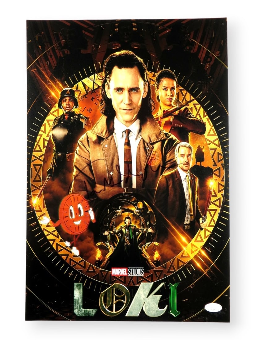 Tom Hiddleston Autographed 12X18 Photo Loki JSA Certified: Tom Hiddleston Autographed 12X18 Photo Loki JSA Certified This is an original 12" x 18" photograph of Tom Hiddleston, famously known for his role as Loki. The photo has been authentically signed by Hi