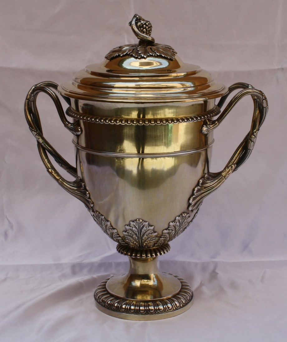 1814 English Sterling Silver Gilt Trophy Cup by William Burwash: 1814 English Sterling Silver Gilt Trophy Cup by William Burwash This magnificent English Sterling Silver Gilt Covered Cup Trophy, crafted by William Burwash in 1814-1815, showcases exquisite design an