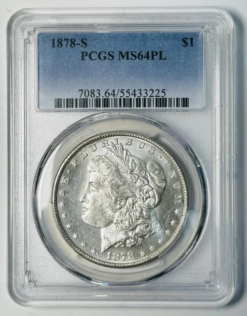 PCGS MS-64 PL 1878-S Morgan Silver Dollar: PCGS MS-64 PL 1878-S Morgan Silver Dollar 1878-S Morgan Silver Dollar certified by PCGS and graded MS-64 PL (Proof Like). This pre-owned silver dollar has a white appearance and carries the $1 denomin