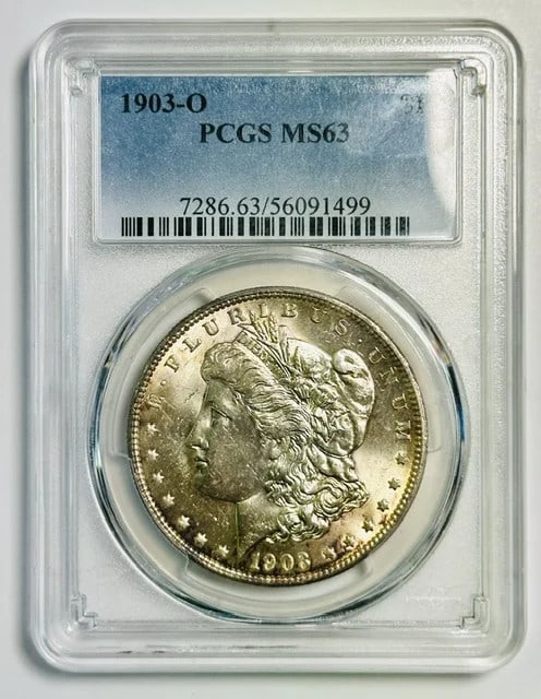 PCGS MS 63 1903 O Morgan Silver Dollar: PCGS MS 63 1903 O Morgan Silver Dollar 1903-O Morgan Silver Dollar certified by PCGS and graded MS-63. This pre-owned United States silver dollar has a New Orleans mint issue and a denomination of one