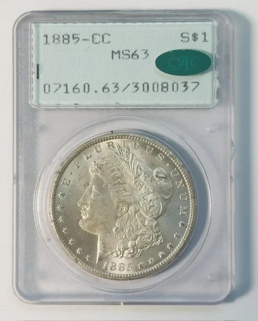 PCGS MS63 CAC 1885 Carson City Morgan Silver Dollar: PCGS MS63 CAC 1885 Carson City Morgan Silver Dollar Pre-owned 1885-CC Morgan Silver Dollar certified by PCGS as MS-63 and approved by CAC. This Carson City issue is presented in a rattler holder. Spec