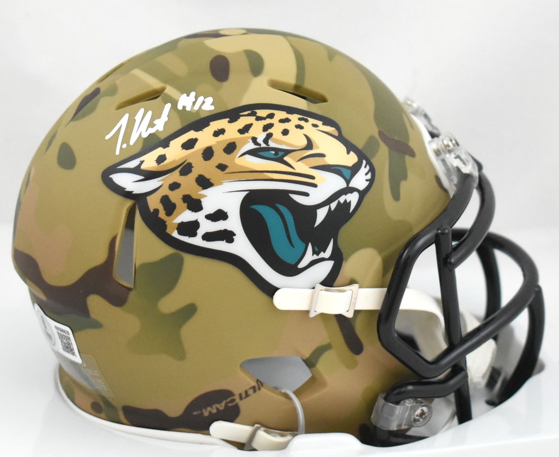 Beckett Authenticated Travis Hunter Jaguars Camo Speed Mini Helmet: Beckett Authenticated Travis Hunter Jaguars Camo Speed Mini Helmet This Jacksonville Jaguars camo Speed mini helmet is signed by Travis Hunter and comes as an original item. It is a football collectib