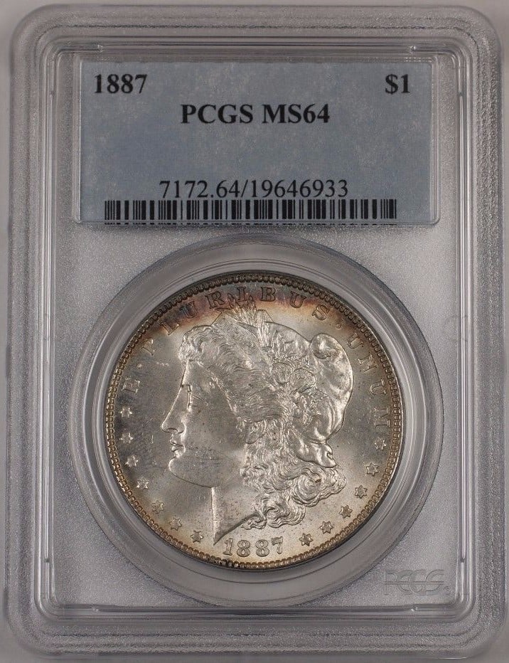 PCGS MS-64 1887 Morgan Silver Dollar $1 Lightly Toned: PCGS MS-64 1887 Morgan Silver Dollar $1 Lightly Toned 1887 Morgan Silver Dollar coin graded PCGS MS-64. This uncirculated silver $1 coin is lightly toned and comes encapsulated in a protective holder.