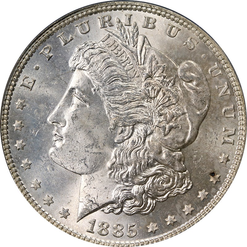 PCGS MS64 1885-P Morgan Silver Dollar in OGH Slight Toning: PCGS MS64 1885-P Morgan Silver Dollar in OGH Slight Toning 1885-P Morgan Silver Dollar certified by PCGS and graded MS64. This uncirculated silver coin has slight toning and is pre-owned. It is a Unit