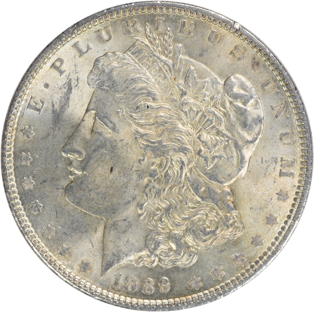 1889 Silver Morgan Dollar Brilliant Uncirculated Uncertified Coin: 1889 Silver Morgan Dollar Brilliant Uncirculated Uncertified Coin This 1889 Morgan Silver Dollar is an uncirculated, pre-owned coin from the United States. Composed of silver, it features no mint mark