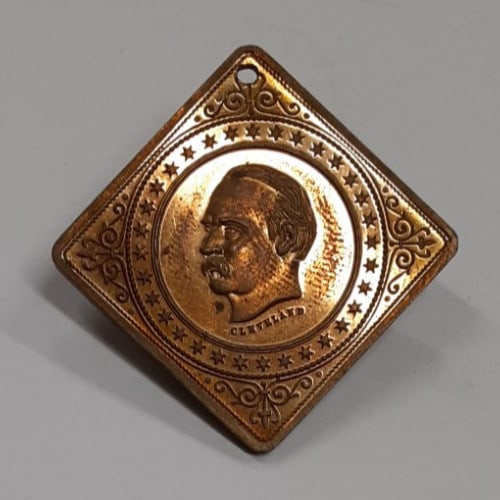Bronze Grover Cleveland Square Medallion with Hanging Hole: Bronze Grover Cleveland Square Medallion with Hanging Hole This vintage President Grover Cleveland medallion is crafted from bronze and features a square shape measuring 27 by 27 millimeters. The meda
