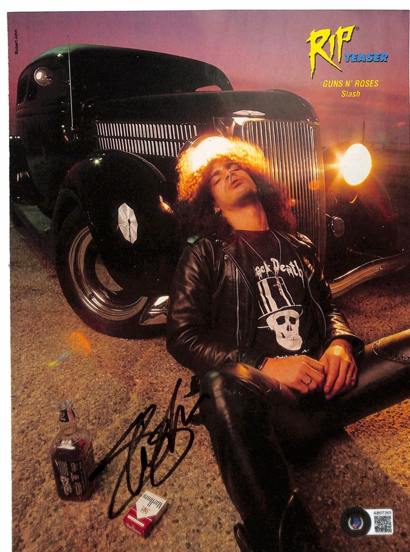 Autographed 8 1/2 X 11 Magazine Photo of Slash Beckett LOA: Autographed 8 1/2 X 11 Magazine Photo of Slash Beckett LOA Original 8 1/2 x 11 color magazine photograph autographed by Slash of Guns N Roses in black permanent marker. The piece comes with Beckett Au
