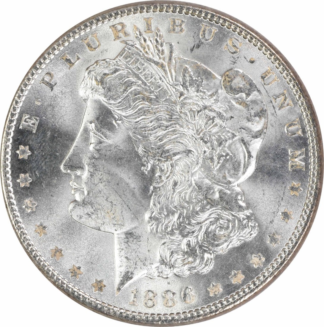 1886 Uncertified Morgan $1 Silver Dollar Uncirculated: 1886 Uncertified Morgan $1 Silver Dollar Uncirculated 1886 Morgan Silver Dollar in uncirculated condition. This pre-owned coin is composed of silver and is listed as uncertified with a grade of MS63. 