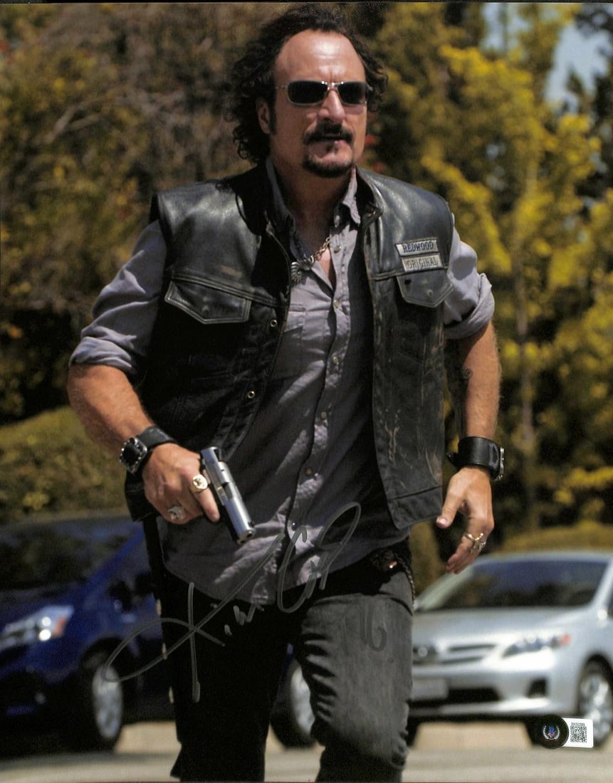 Beckett Certified 11x14 Sons of Anarchy Tig Photo Signed by Kim Coates: Beckett Certified 11x14 Sons of Anarchy Tig Photo Signed by Kim Coates Pre-owned 11x14 photograph from Sons of Anarchy, hand-signed by Kim Coates and inscribed "Tig." The autograph has been authentica