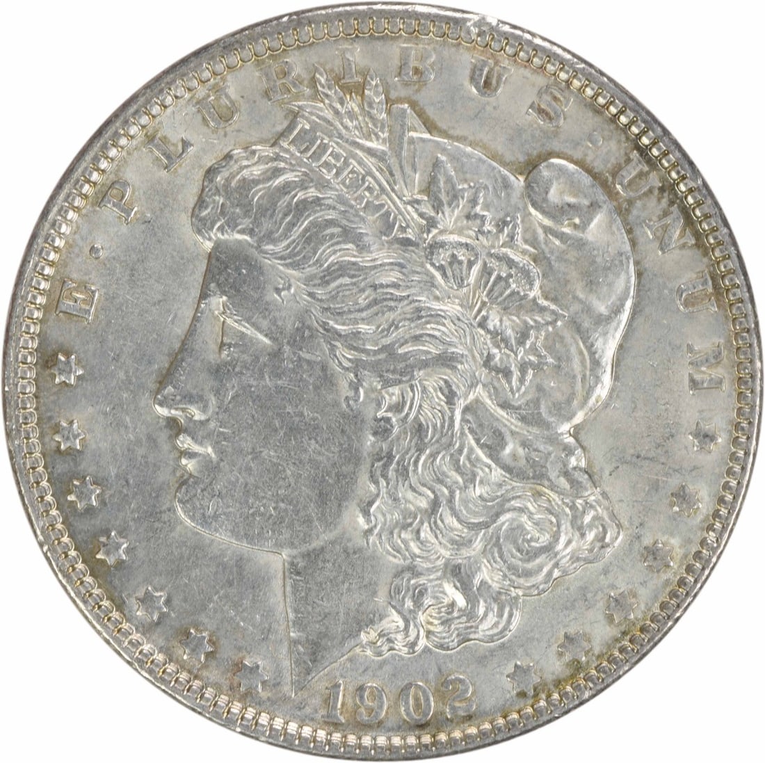 1902 Morgan Silver Dollar AU Uncertified 90% Silver Coin: 1902 Morgan Silver Dollar AU Uncertified 90% Silver Coin This 1902 Morgan Silver Dollar is an ungraded coin with an AU (Almost Uncirculated) grade, showcasing its historical significance and beauty. S
