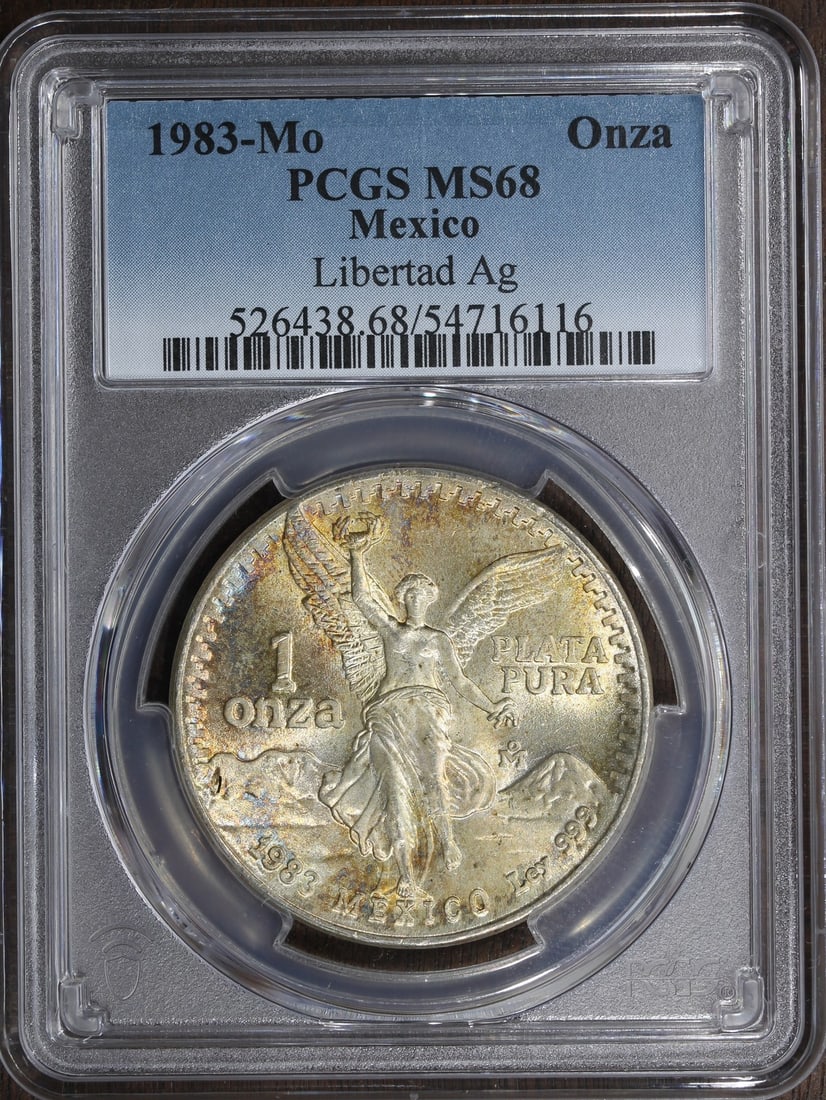 PCGS MS68 1983-Mo Mexico 1 oz Silver Libertad Onza Toned: PCGS MS68 1983-Mo Mexico 1 oz Silver Libertad Onza Toned 1983 Mexico 1 oz Silver Libertad Onza coin graded MS 68 by PCGS. It is composed of 0.999 fine silver and is listed in pre-owned condition. The 
