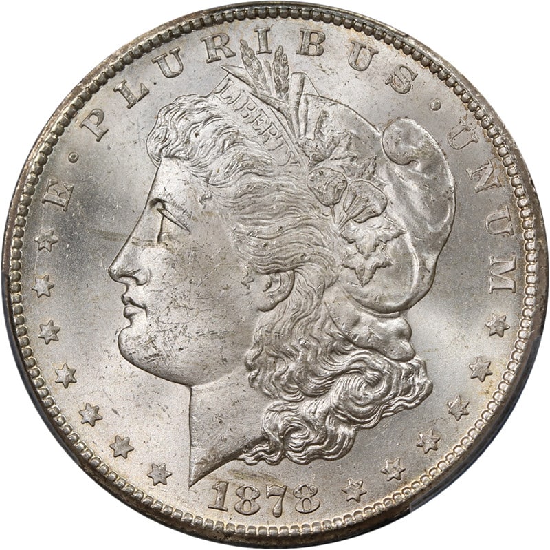 PCGS MS63+ 1878-CC Morgan Silver Dollar Blast White: PCGS MS63+ 1878-CC Morgan Silver Dollar Blast White Original 1878-CC Morgan Silver Dollar graded PCGS MS63+. This uncirculated silver coin is described as blast white with nice eye appeal, nice luster