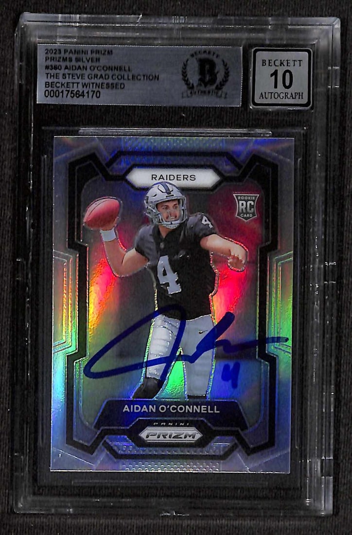 Beckett 10 Autographed 2023 Panini Prizm Silver #360 Aidan O'Connell Card: Beckett 10 Autographed 2023 Panini Prizm Silver #360 Aidan O'Connell Card Original 2023 Panini Prizm Silver #360 sports trading card autographed by Aidan O'Connell. The card is signed in blue permanen