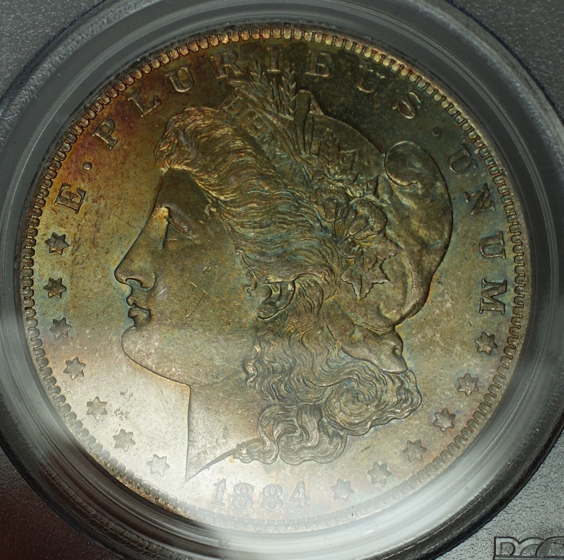 PCGS MS-65 1884-O Morgan Dollar Toned Gem: PCGS MS-65 1884-O Morgan Dollar Toned Gem This 1884-O Morgan Silver Dollar is an uncirculated coin graded MS-65 by PCGS. Struck at the New Orleans Mint, it is composed of silver and features attractiv