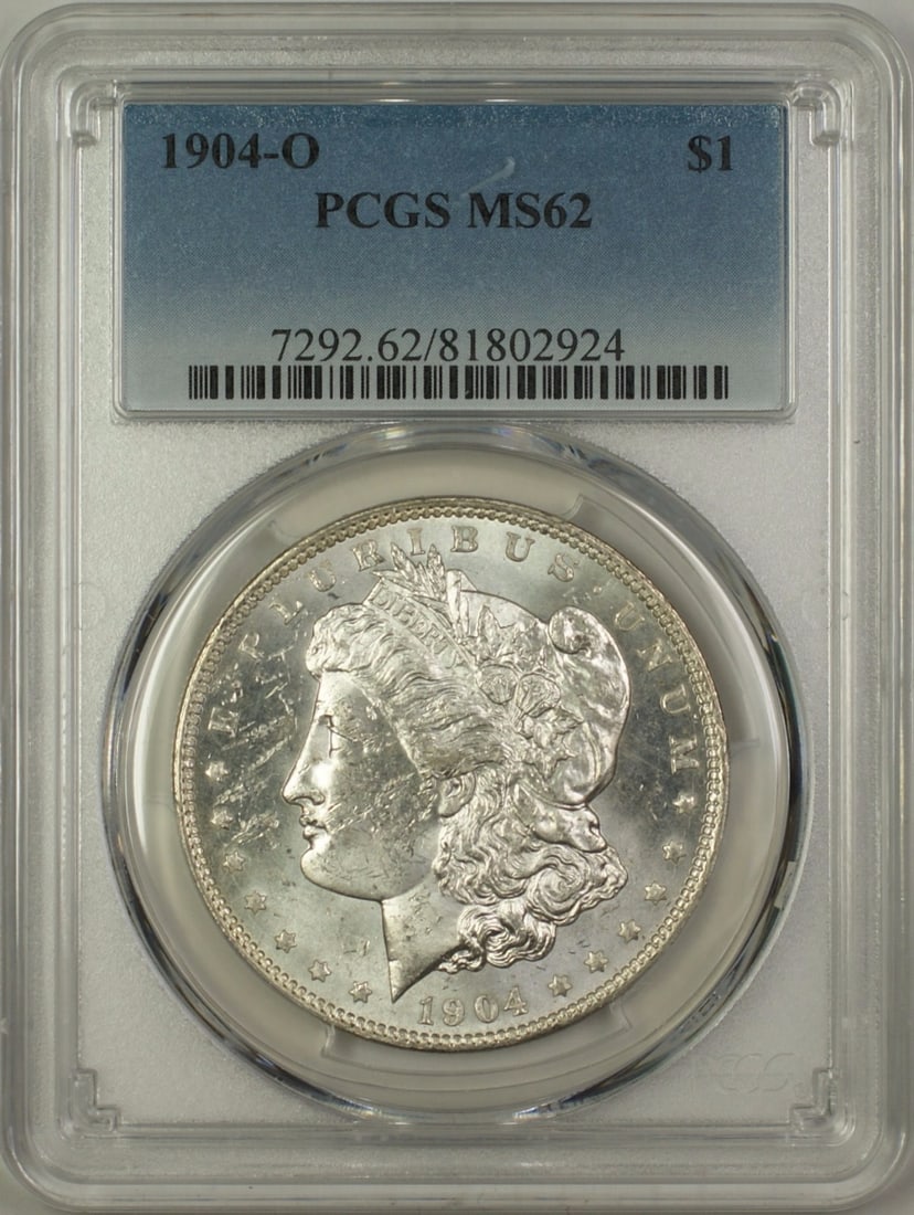 PCGS MS-62 1904-O Morgan $1 Silver Dollar: PCGS MS-62 1904-O Morgan $1 Silver Dollar 1904-O Morgan Silver Dollar $1 coin from the United States, certified by PCGS and graded MS-62. This uncirculated silver coin is a pre-owned example of the cl