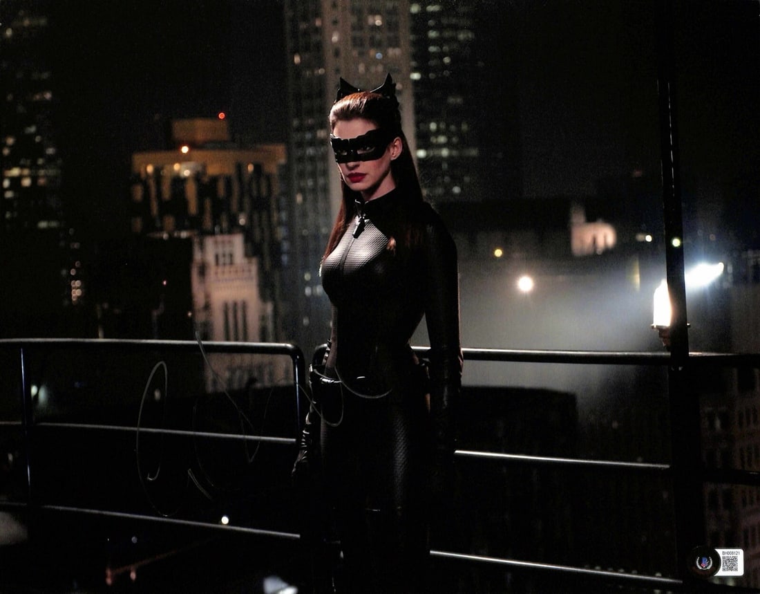 Beckett Certified Anne Hathaway Signed Cat Woman 11x14 Photo: Beckett Certified Anne Hathaway Signed Cat Woman 11x14 Photo Original 11x14 photograph from The Dark Knight Rises, signed by Anne Hathaway in silver permanent marker. This autographed piece is authent