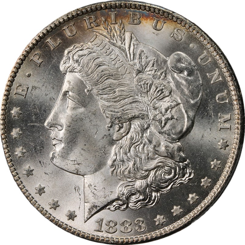 PCGS MS63 1883 CC Morgan Silver Dollar: PCGS MS63 1883 CC Morgan Silver Dollar This 1883-CC Morgan Silver Dollar is graded MS63 by PCGS, indicating an uncirculated coin with impressive eye appeal. It features fantastic luster, a strong stri