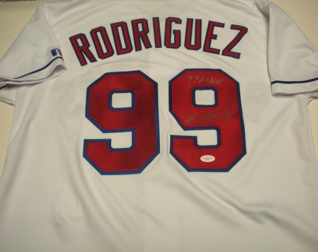 Official Russell Texas Rangers Jersey Signed by Ivan Rodriguez JSA COA 99 AL MVP: Official Russell Texas Rangers Jersey Signed by Ivan Rodriguez JSA COA 99 AL MVP Pre-owned official licensed Russell baseball jersey signed by Ivan Rodriguez and noted as Rangers 99 ALMVP. This is an 