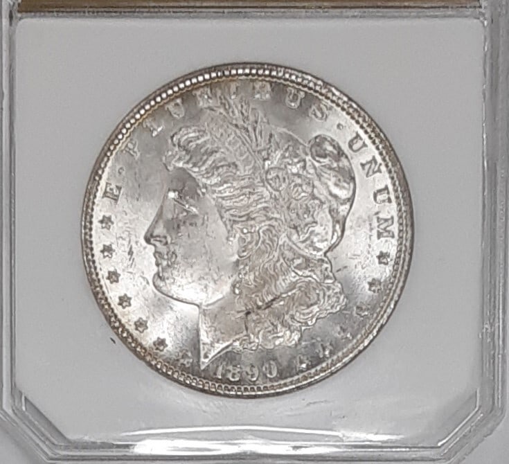 Uncirculated 1890 Carson City Morgan Silver Dollar in Protective Holder: Uncirculated 1890 Carson City Morgan Silver Dollar in Protective Holder This 1890-CC Morgan Silver Dollar is a $1 coin from the United States featuring the Carson City mint mark. Composed of 0.9 fine 