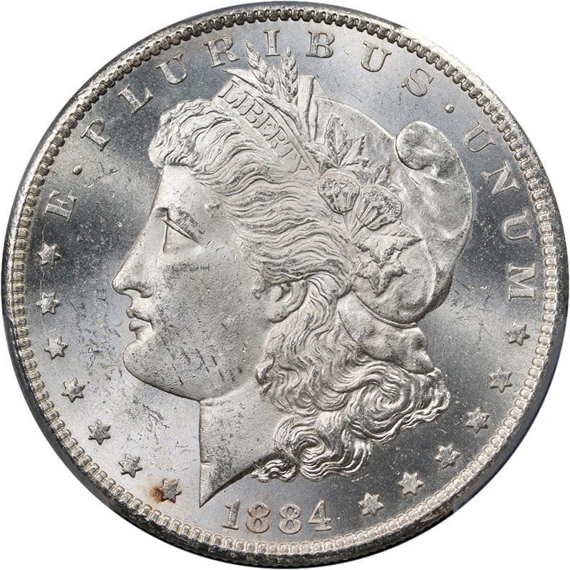 PCGS MS63 1884 CC Morgan Silver Dollar Blast White: PCGS MS63 1884 CC Morgan Silver Dollar Blast White Original 1884-CC Morgan Silver Dollar graded PCGS MS63. This uncirculated silver coin is described as blast white with superb eye appeal, fantastic l