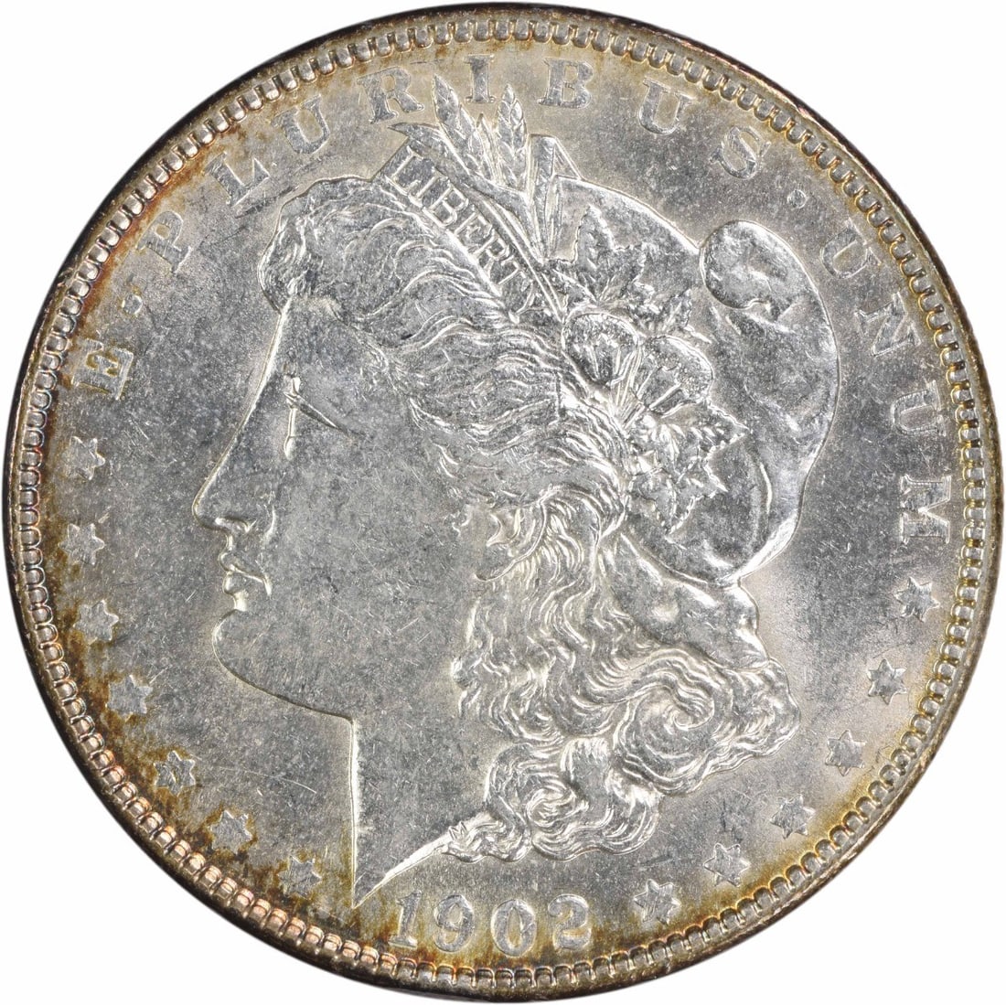 1902 Morgan Silver Dollar AU Uncertified 90% Silver Coin: 1902 Morgan Silver Dollar AU Uncertified 90% Silver Coin This 1902 Morgan Silver Dollar is a distinguished piece, showcasing the artistry of designer George T. Morgan. With a grade of AU (Almost Uncir