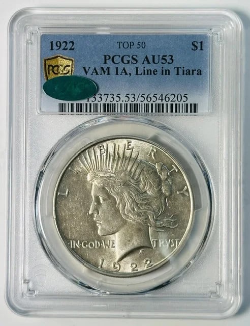 1922 Peace Dollar VAM 1A Line in Tiara PCGS AU53 CAC: 1922 Peace Dollar VAM 1A Line in Tiara PCGS AU53 CAC 1922 Peace Dollar certified by PCGS and CAC, featuring the VAM 1A "Line in Tiara" variety, also noted as a Top 50 attribution. This silver dollar i