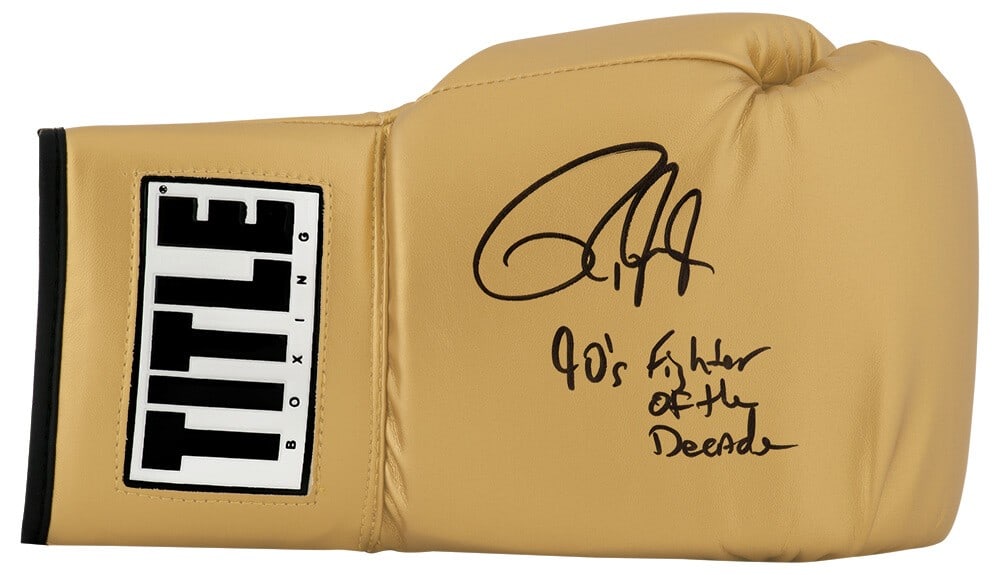 Roy Jones Jr. Signed Title Gold Boxing Glove '90's Fighter of the Decade SS COA: Roy Jones Jr. Signed Title Gold Boxing Glove '90's Fighter of the Decade SS COA Celebrate the legacy of boxing with this remarkable Roy Jones Jr. signed Title gold boxing glove, featuring the inscript