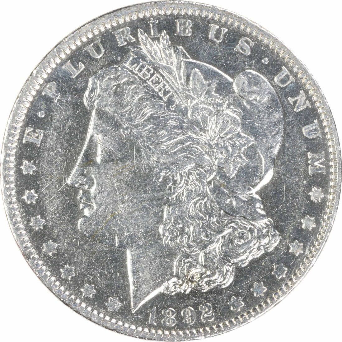 1892 AU Morgan $1 Silver Coin Uncertified: 1892 AU Morgan $1 Silver Coin Uncertified 1892 Morgan Silver Dollar in AU grade. This pre-owned coin is uncertified and listed as circulated, with silver composition and a $1 denomination. Specificati